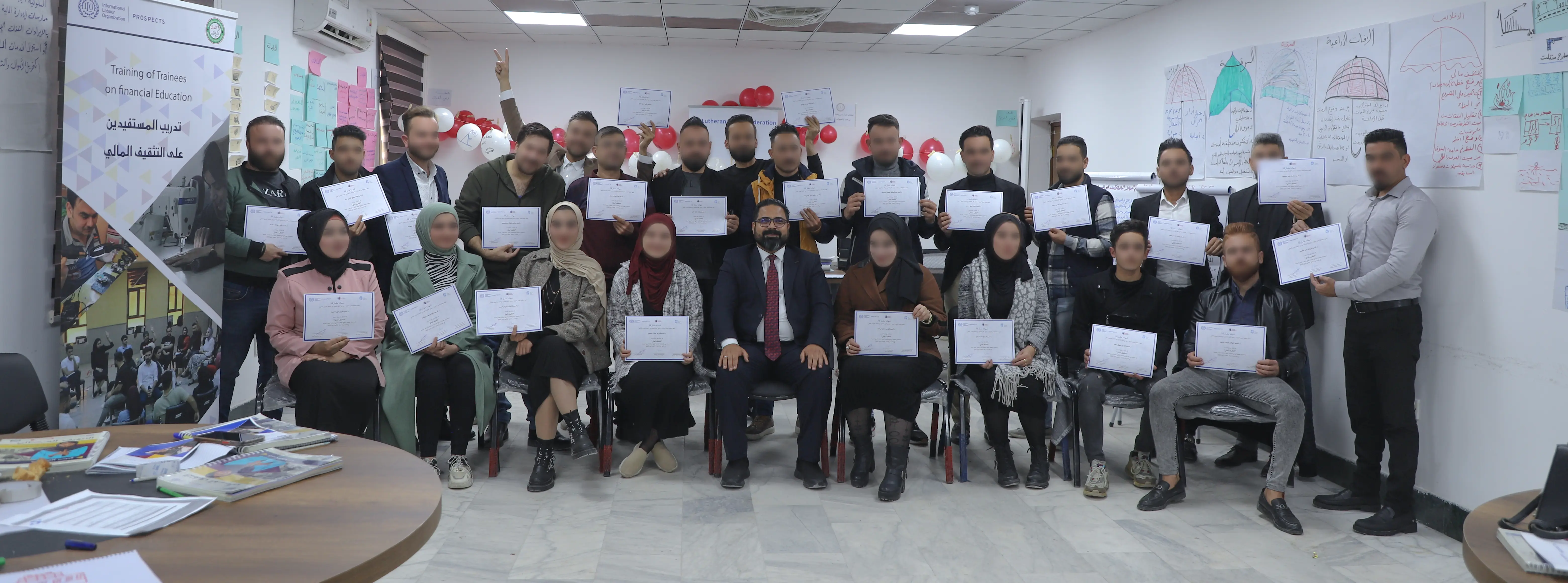 start your business course beneficiaries sitting at tables in al mosul center hall