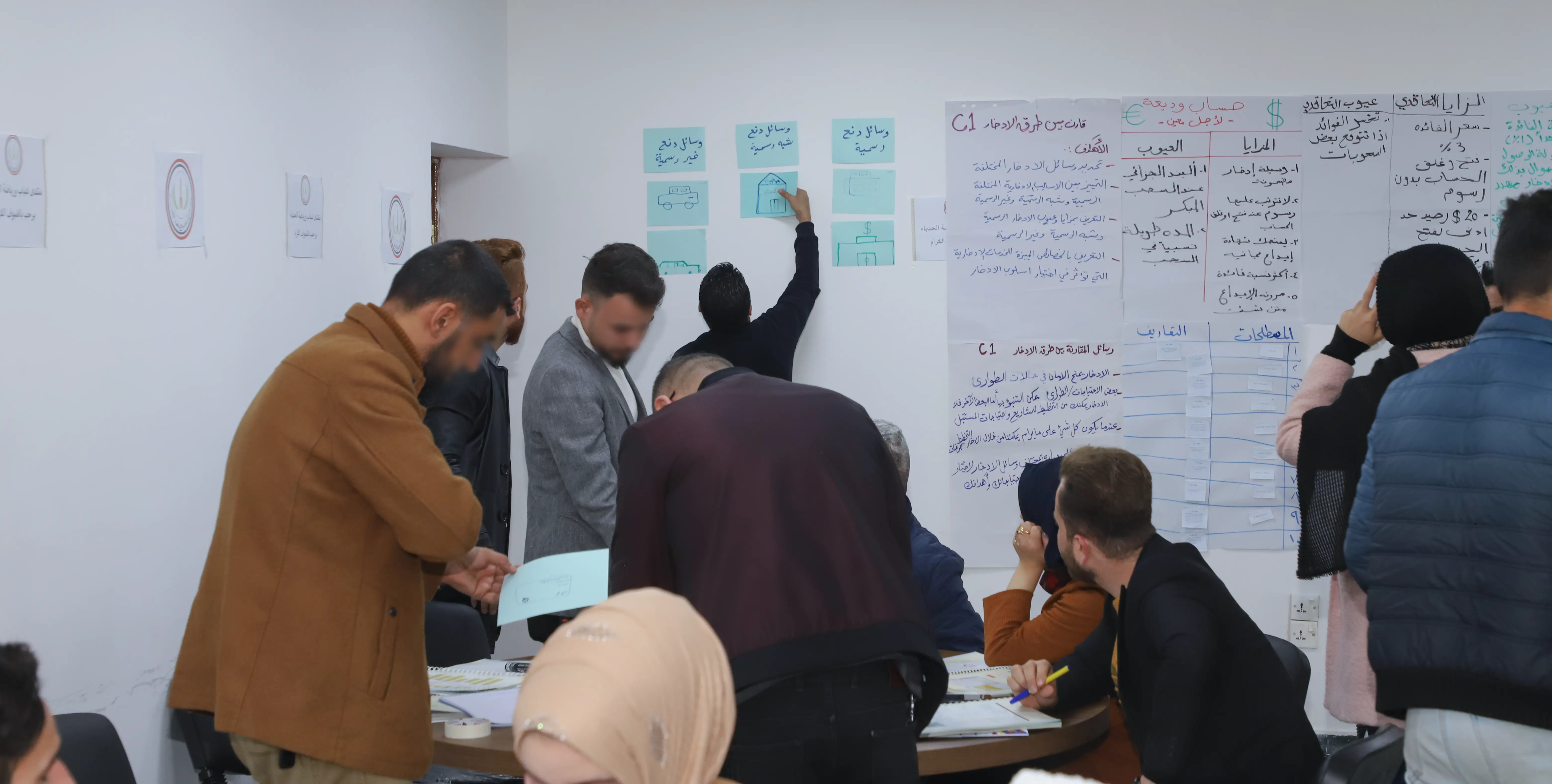 start your business course beneficiaries sitting at tables in al mosul center hall