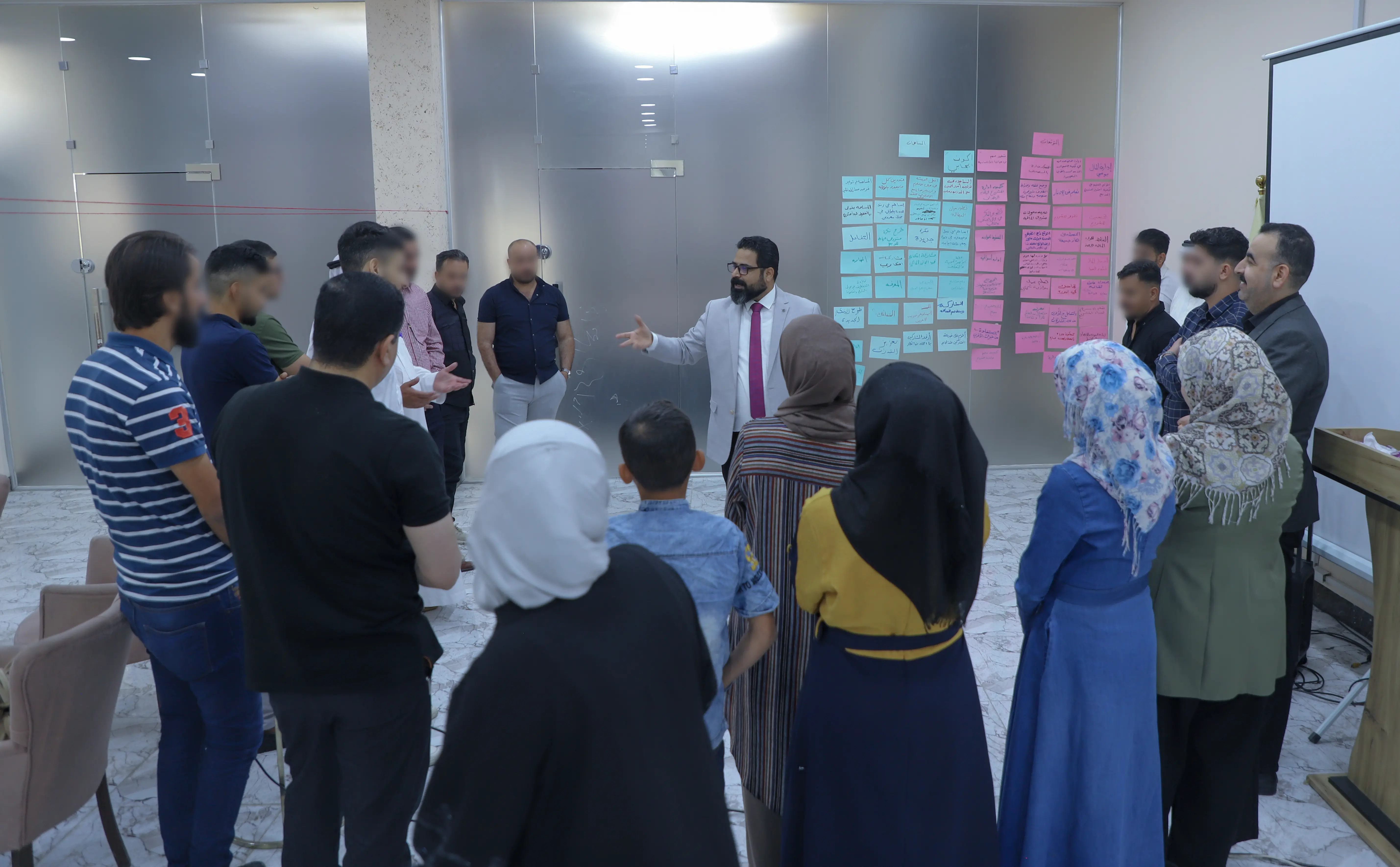 Yahya Abd Mahjoub and a group of beneficiaries discussing financial goals in the financial Education course